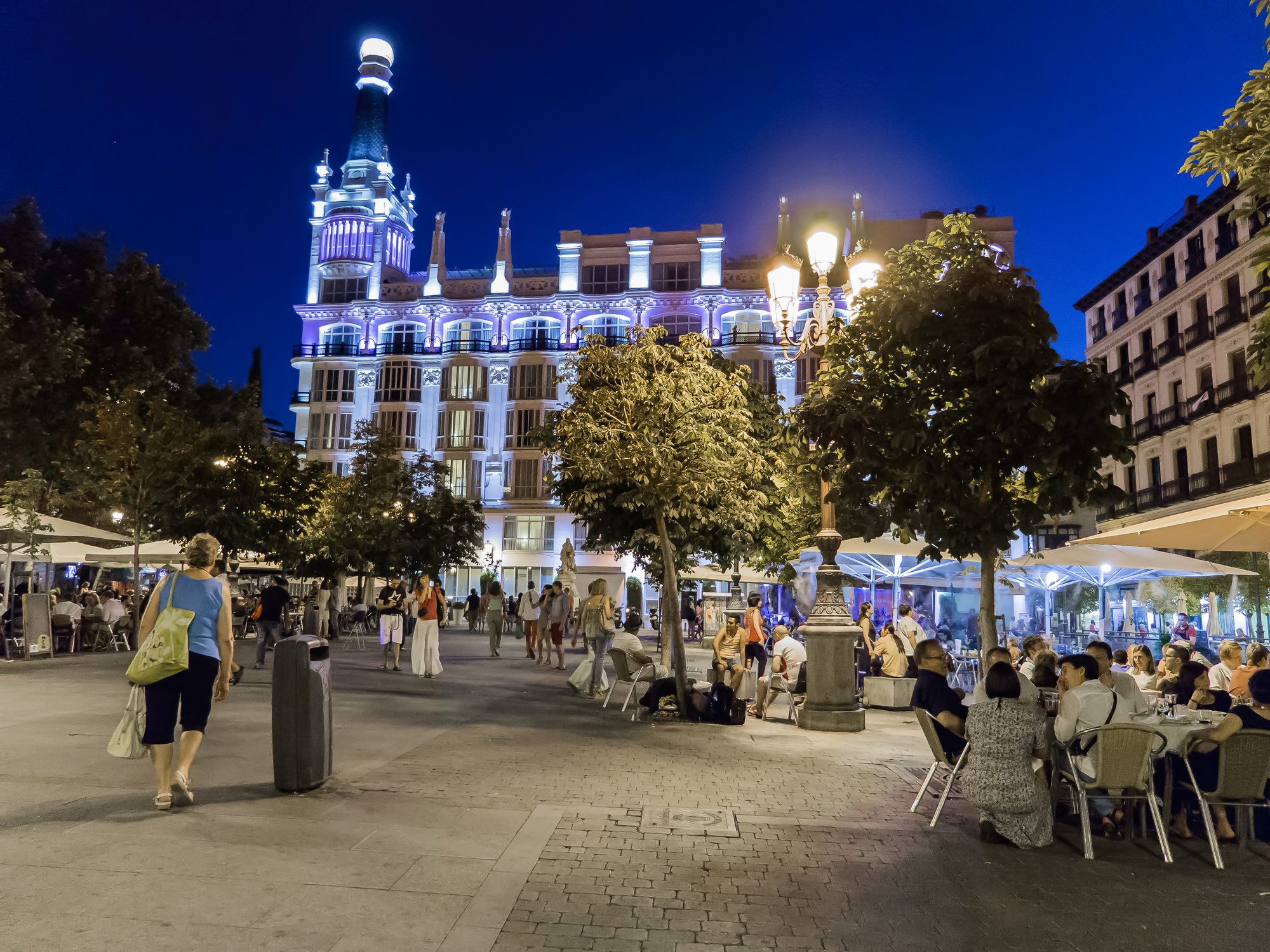 Outdoor dining on a Madrid square at night